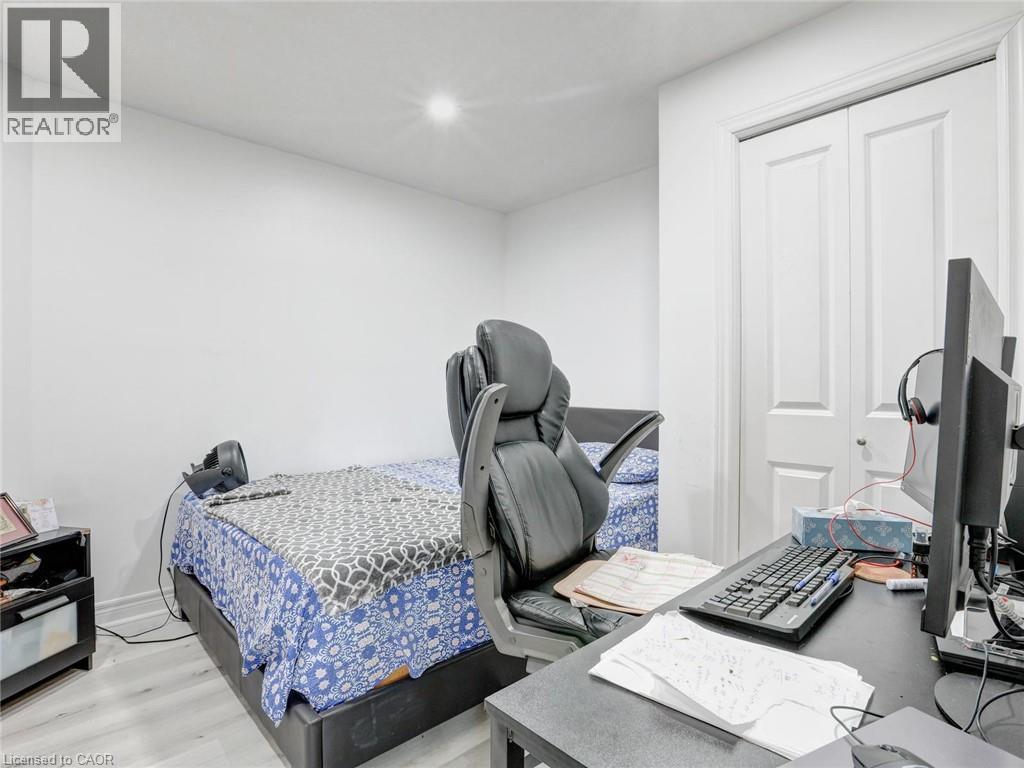 Bedroom featuring light-tone wood-finish flooring, white walls, and a recessed ceiling light - 584 Pinery Trail, Waterloo, ON - Indoor Photo Showing Bedroom