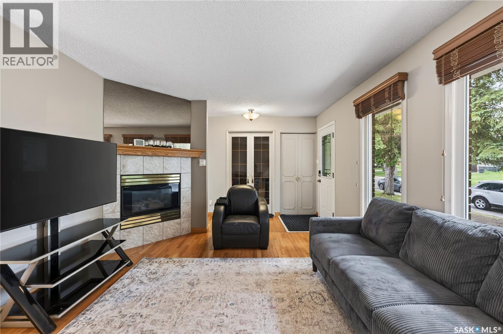 12 Jackson Bay, Regina, SK - Indoor Photo Showing Living Room With Fireplace