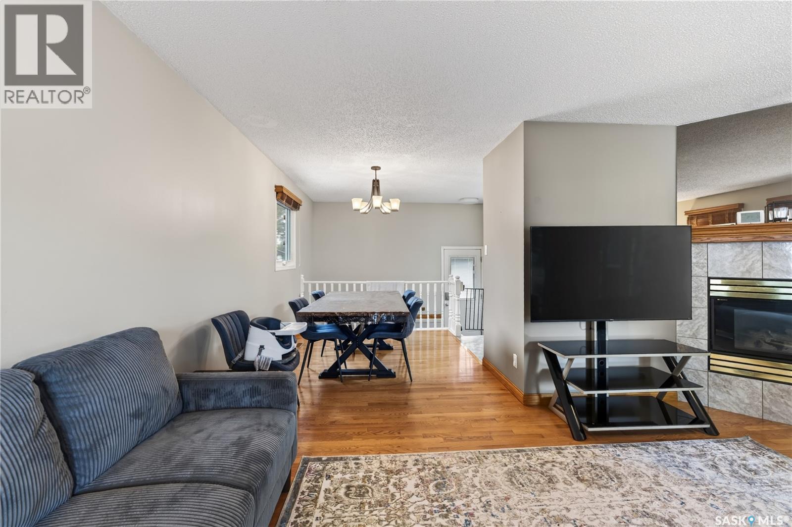 12 Jackson Bay, Regina, SK - Indoor Photo Showing Living Room With Fireplace