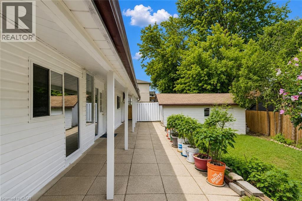 Covered patio featuring a concrete slab and white support columns - 182 Avalon Place, Kitchener, ON - Outdoor