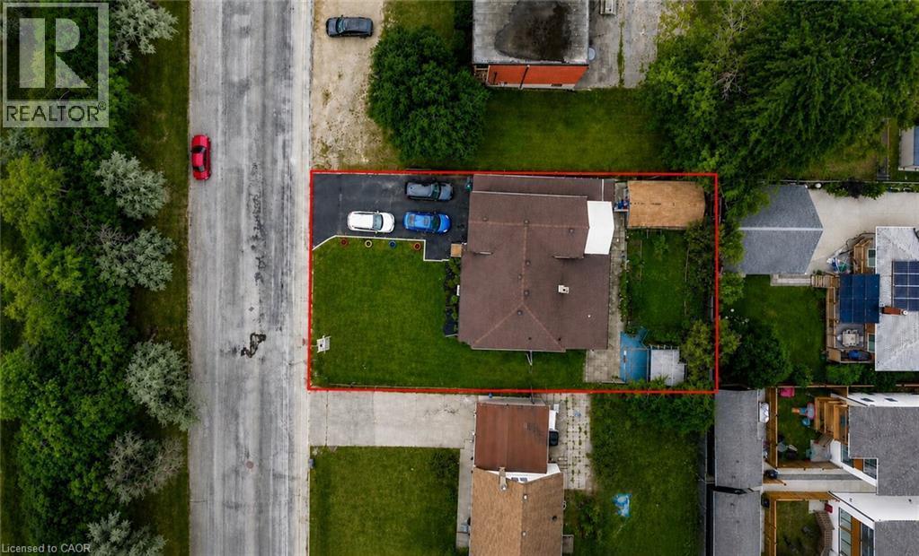 Expansive corner lot featuring a private paved driveway, a large rear yard, and a detached outbuilding - 182 Avalon Place, Kitchener, ON - Outdoor