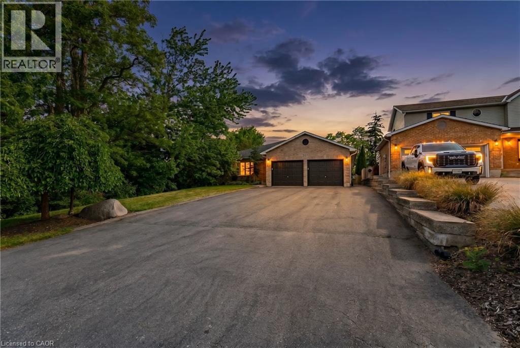 Elegant brick home with a spacious asphalt driveway and two-car garage - 907 Doon Village Road, Kitchener, ON - Outdoor