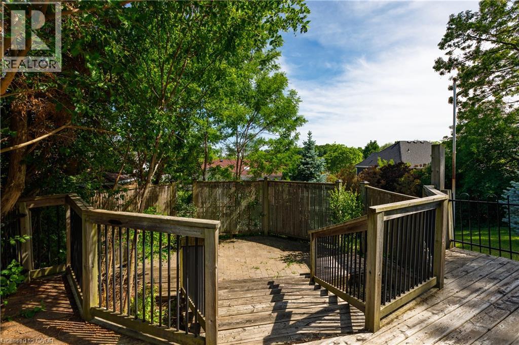 Outdoor wood deck featuring integrated stairs and dark-toned metal balusters - 907 Doon Village Road, Kitchener, ON - Outdoor With Deck Patio Veranda
