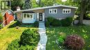 Split-level residence featuring a brick and siding facade, a bay window, a concrete pathway, mature landscaping, and a retaining wall - 69 Pleasant Avenue, Hamilton, ON  - Outdoor 