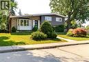 Split-level residence featuring a stone and siding exterior, a prominent bay window, and a black front door - 69 Pleasant Avenue, Hamilton, ON  - Outdoor 