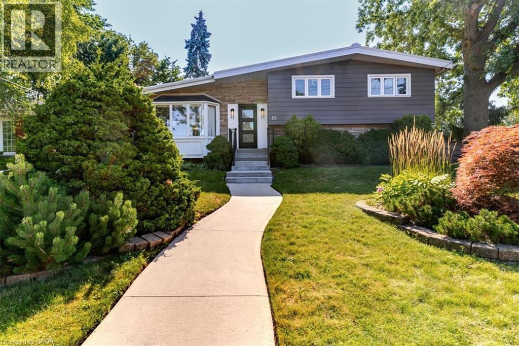 Split-level residence featuring a gray siding exterior and white trim accents - 69 Pleasant Avenue, Hamilton, ON - Outdoor