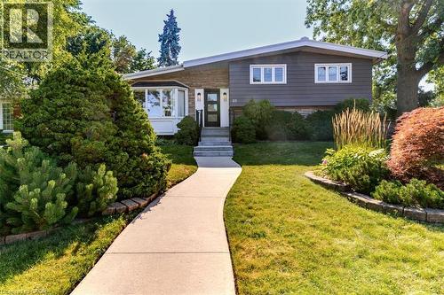 Split-level residence featuring a gray siding exterior and white trim accents - 69 Pleasant Avenue, Hamilton, ON - Outdoor