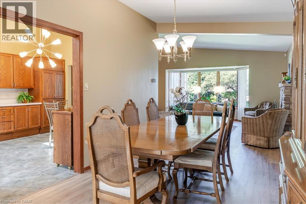 Elegant dining room showcasing a wood-finish dining table with seating for eight, complemented by upholstered chairs with caned backs - 69 Pleasant Avenue, Hamilton, ON - Indoor Photo Showing Dining Room