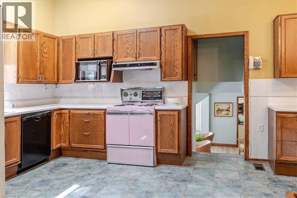 Kitchen featuring wood cabinetry, white countertops, white subway tile backsplash, and a pink range - 69 Pleasant Avenue, Hamilton, ON - Indoor Photo Showing Kitchen