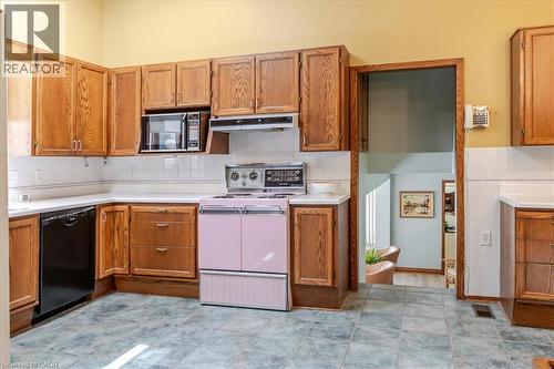 Kitchen featuring wood cabinetry, white countertops, white subway tile backsplash, and a pink range - 69 Pleasant Avenue, Hamilton, ON - Indoor Photo Showing Kitchen