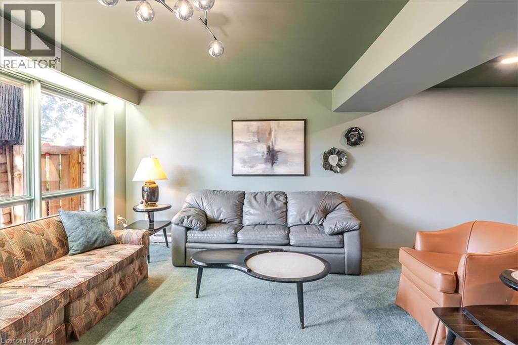 Living area featuring a green ceiling, light-colored walls, and carpeting - 69 Pleasant Avenue, Hamilton, ON - Indoor Photo Showing Living Room