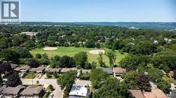 Expansive green space featuring two baseball diamonds surrounded by mature trees - 