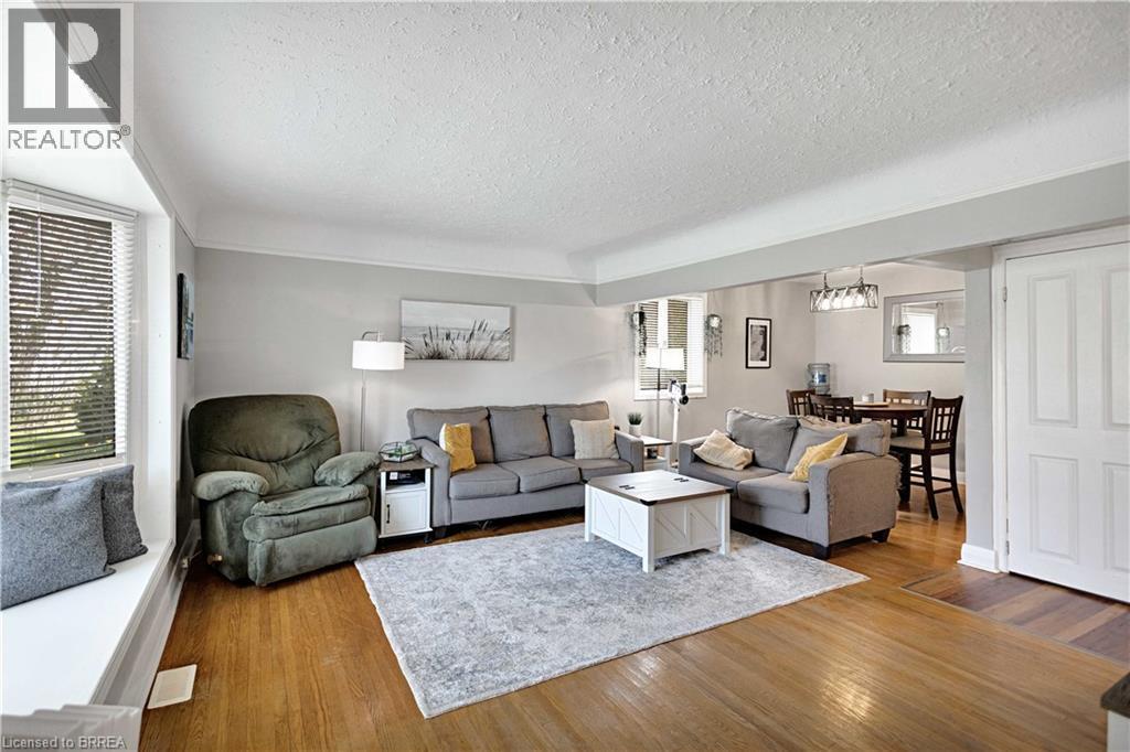 Wood-finish flooring throughout the main living area - 371 Ottawa Street S, Kitchener, ON - Indoor Photo Showing Living Room