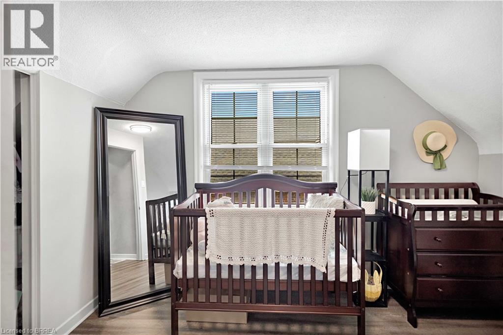 Room with sloped ceilings, light gray walls, white trim, and a window with horizontal blinds - 371 Ottawa Street S, Kitchener, ON - Indoor Photo Showing Bedroom