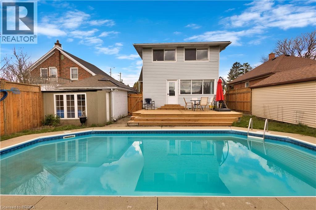 Expansive inground pool with concrete surround - 371 Ottawa Street S, Kitchener, ON - Outdoor With In Ground Pool