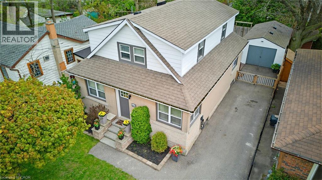 Two-story residence featuring light brick and white siding, a multi-gabled roof, and a front entry with stone steps - 60 Avenue Road, Cambridge, ON - Outdoor