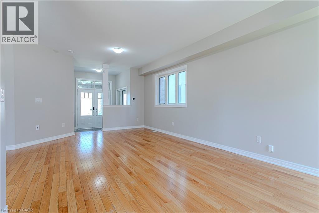 Expansive room featuring light wood-finish flooring, neutral wall tones, and recessed lighting - 3896 Tufgar Crescent, Burlington, ON - Indoor Photo Showing Other Room