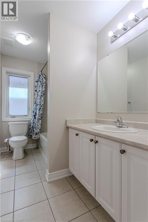 Full bathroom featuring a white vanity with panel doors, an integrated sink, and a light-toned countertop - 3896 Tufgar Crescent, Burlington, ON - Indoor Photo Showing Bathroom