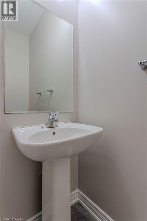 Pedestal sink with chrome faucet set against light gray walls - 3896 Tufgar Crescent, Burlington, ON - Indoor Photo Showing Bathroom
