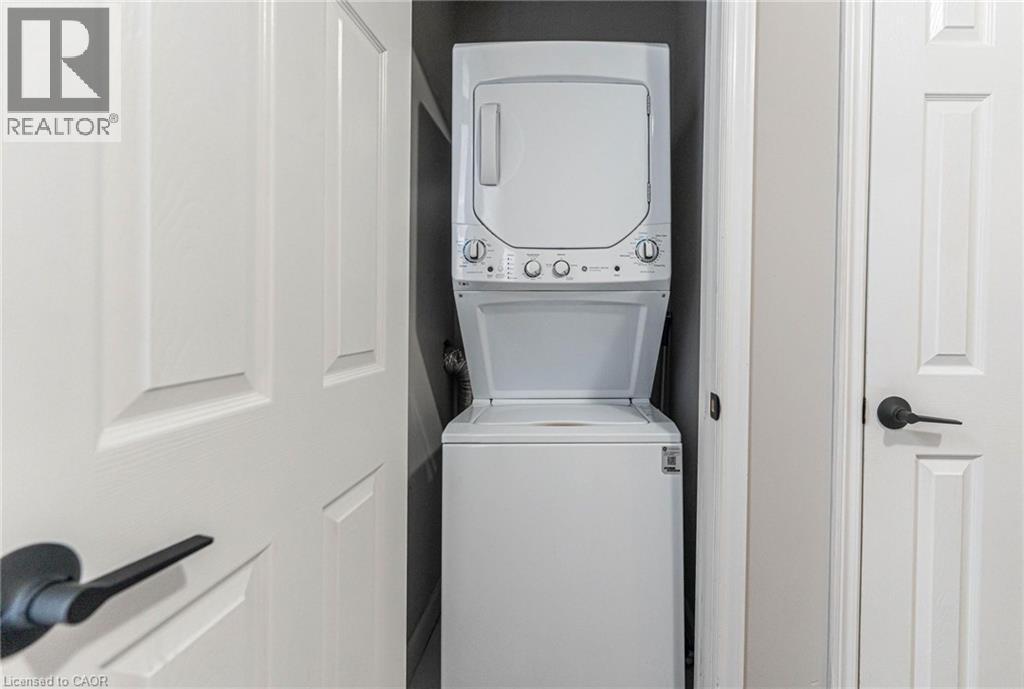 Laundry room featuring stacked washer and clothes dryer - 222 Kensington Avenue N, Hamilton, ON - Indoor Photo Showing Laundry Room