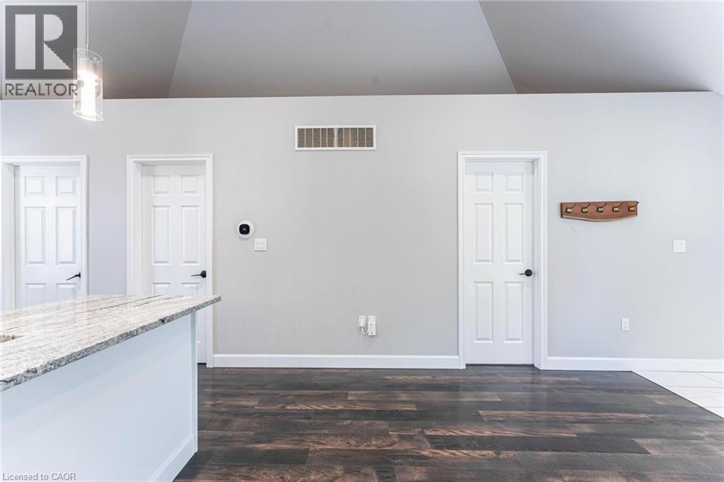Unfurnished living room featuring dark wood finished floors and baseboards - 222 Kensington Avenue N, Hamilton, ON - Indoor Photo Showing Other Room