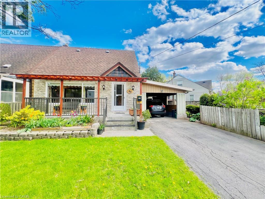 Stone facade residence featuring a covered front porch with a wood pergola, a front lawn, and a paved driveway leading to a carport - 56 Eastvale Place, Hamilton, ON - Outdoor With Deck Patio Veranda