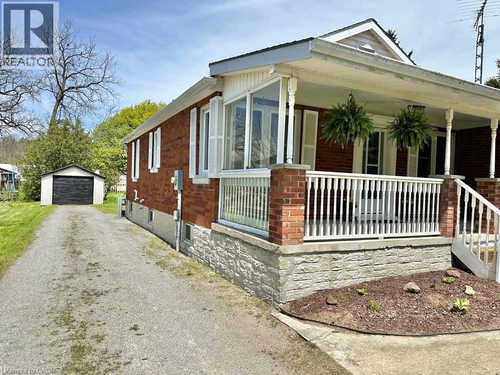 Brick exterior with white shutters and a white porch railing - 165 Highway 6, Simcoe, ON - Outdoor