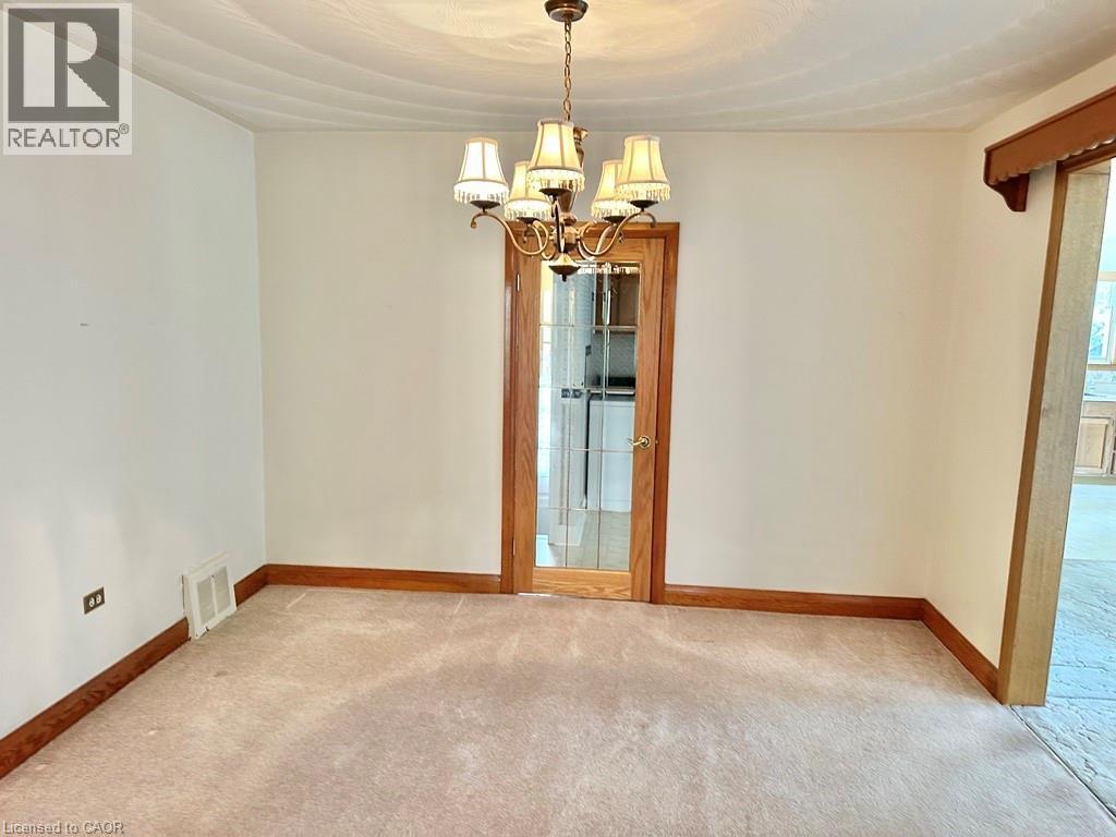 Room featuring carpet flooring, white walls, and wood trim - 165 Highway 6, Simcoe, ON - Indoor Photo Showing Other Room