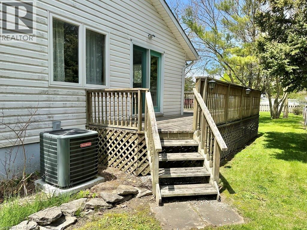 Expansive rear deck featuring wood construction, latticework skirting - 165 Highway 6, Simcoe, ON - Outdoor