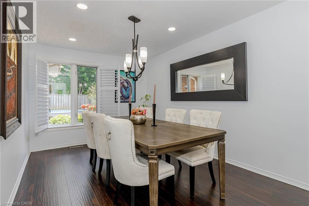 Dining room with dark wood finished floors and suspended lighting - 32 Vineberg Drive, Hamilton, ON - Indoor Photo Showing Dining Room