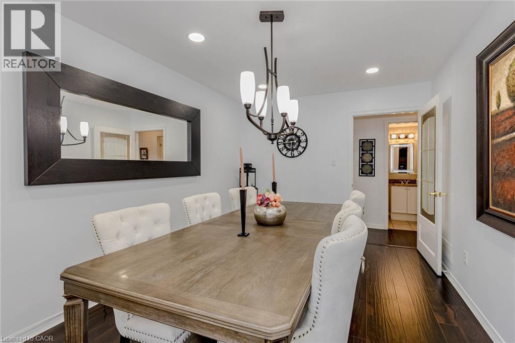 Dining area with dark wood-style flooring and a chandelier - 32 Vineberg Drive, Hamilton, ON - Indoor Photo Showing Dining Room