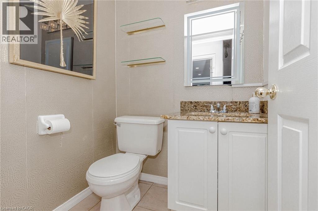 Half bathroom featuring vanity and light tile patterned flooring - 32 Vineberg Drive, Hamilton, ON - Indoor Photo Showing Bathroom