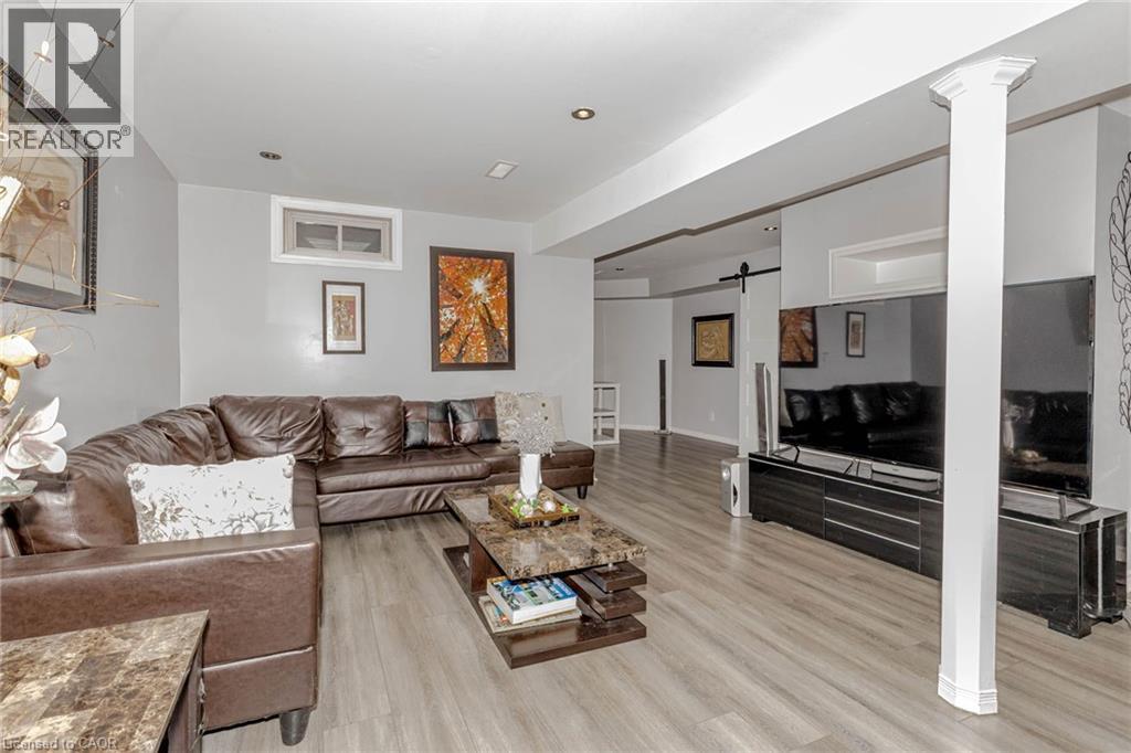 Living area featuring a barn door, light wood finished floors, and recessed lighting - 32 Vineberg Drive, Hamilton, ON - Indoor Photo Showing Living Room