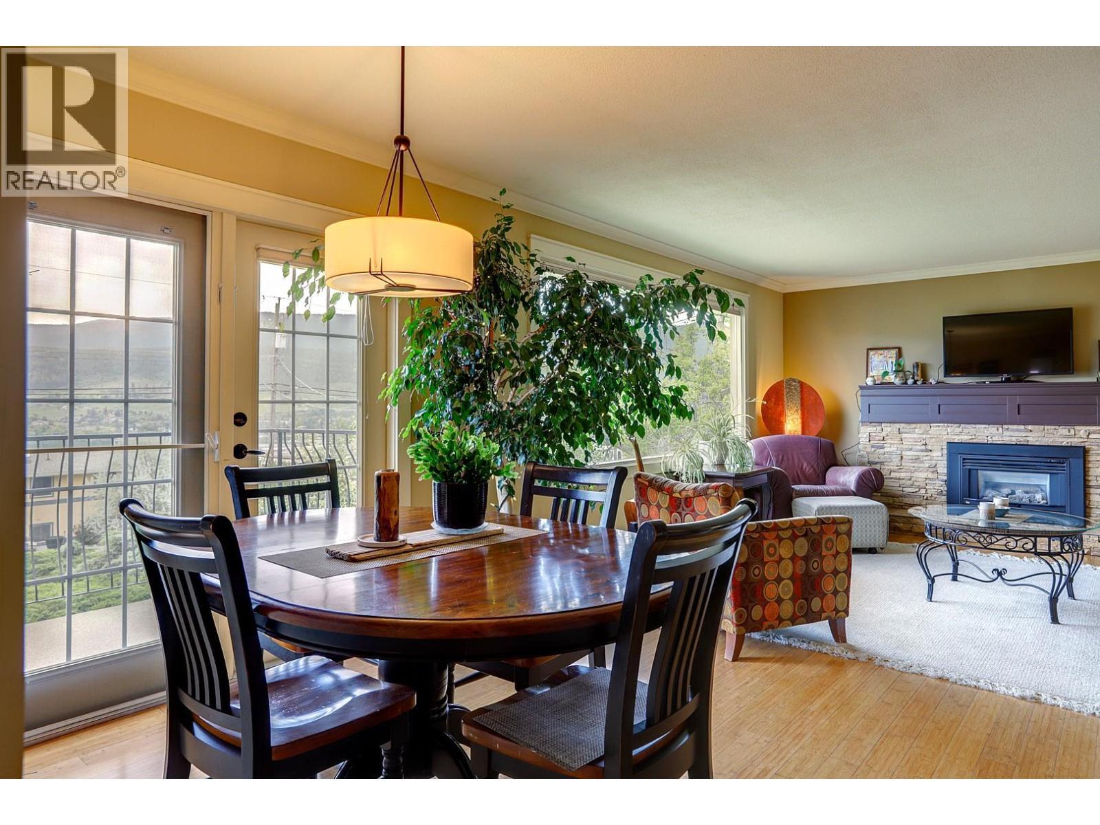 8308 Kalview Drive, Coldstream, BC - Indoor Photo Showing Dining Room With Fireplace