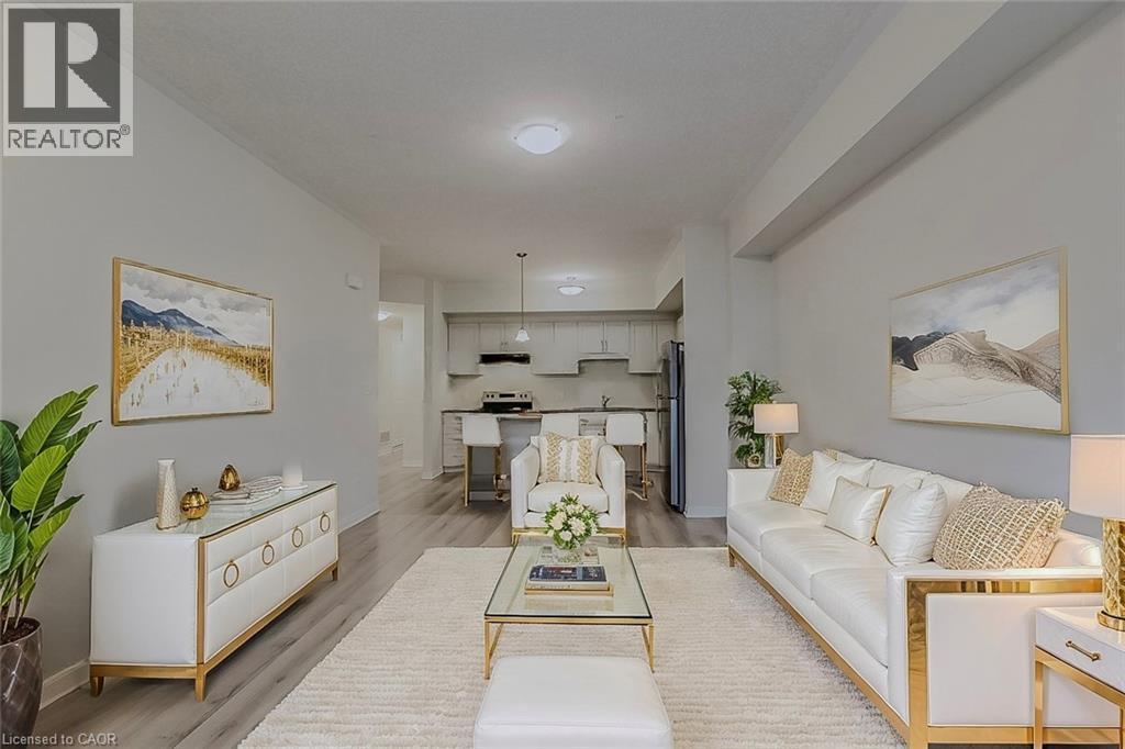 Living area featuring light wood-style flooring and baseboards - 25 Isherwood Avenue Unit# G-105, Cambridge, ON - Indoor Photo Showing Living Room