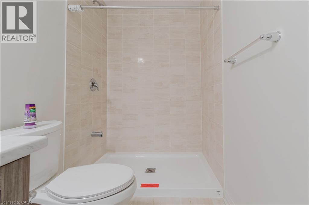 Bathroom featuring a tile shower and toilet - 25 Isherwood Avenue Unit# G-105, Cambridge, ON - Indoor Photo Showing Bathroom