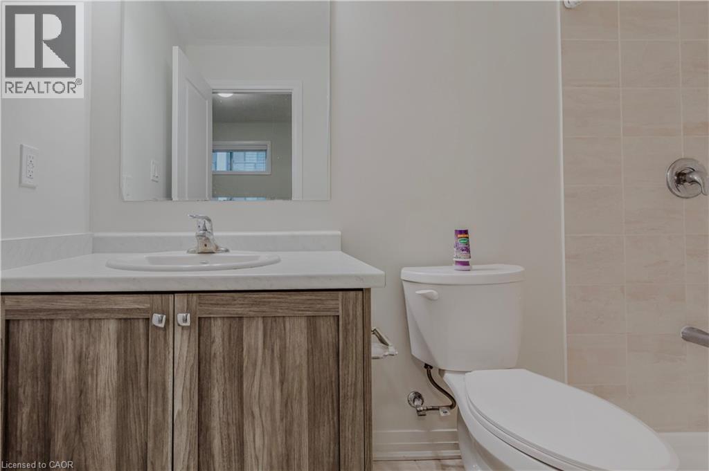Bathroom with vanity, a tile shower, and toilet - 25 Isherwood Avenue Unit# G-105, Cambridge, ON - Indoor Photo Showing Bathroom