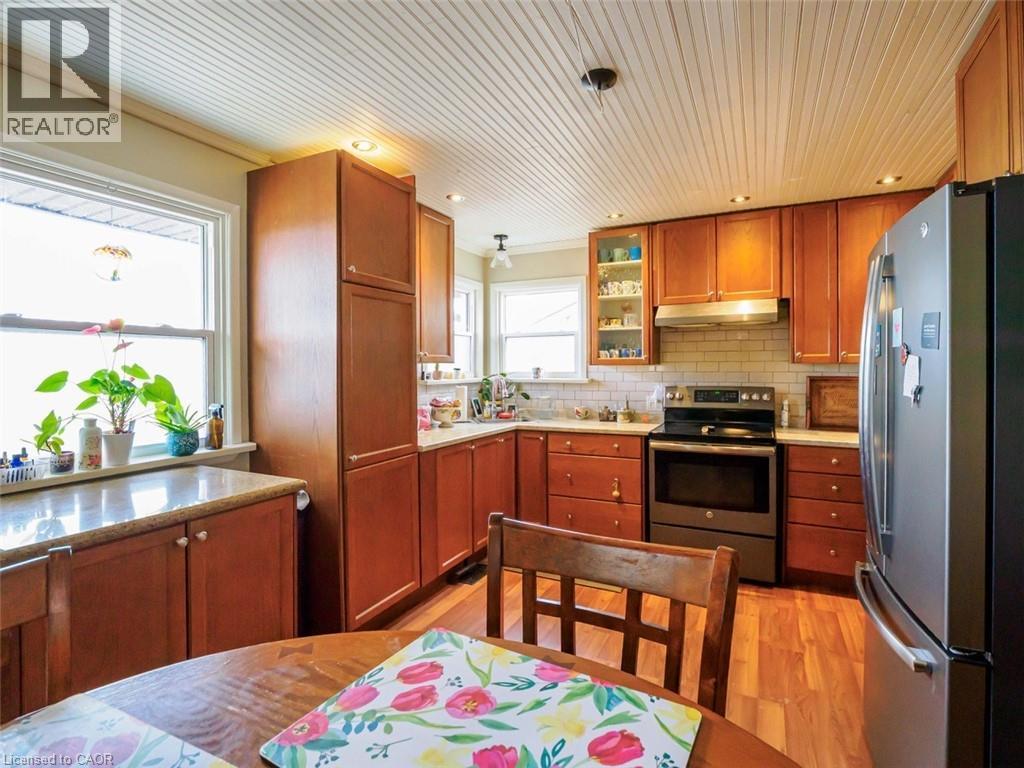 Larger kitchen window looks out to lake over front porch. Corner windows look south east towards lake - 1395 Lakeshore Road, Haldimand County, ON - Indoor Photo Showing Kitchen