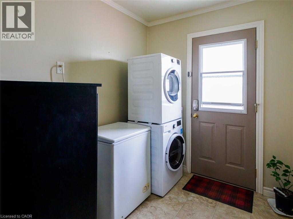 Back door to deck and back yard. Utility space and laundry/mud room - 1395 Lakeshore Road, Haldimand County, ON - Outdoor With View