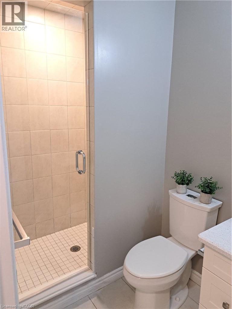 Glass-enclosed shower with subway tile surround and grid pattern floor - 26 Wheat Lane, Kitchener, ON - Indoor Photo Showing Bathroom