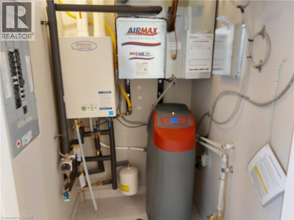 Utility closet featuring a tankless water heater, water softener system, and electrical panel - 26 Wheat Lane, Kitchener, ON - Indoor Photo Showing Basement
