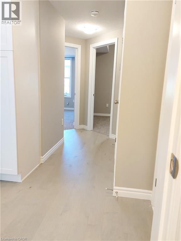 Hallway featuring light wood-finish flooring, neutral-toned walls, white trim, and recessed lighting - 26 Wheat Lane, Kitchener, ON - Indoor Photo Showing Other Room