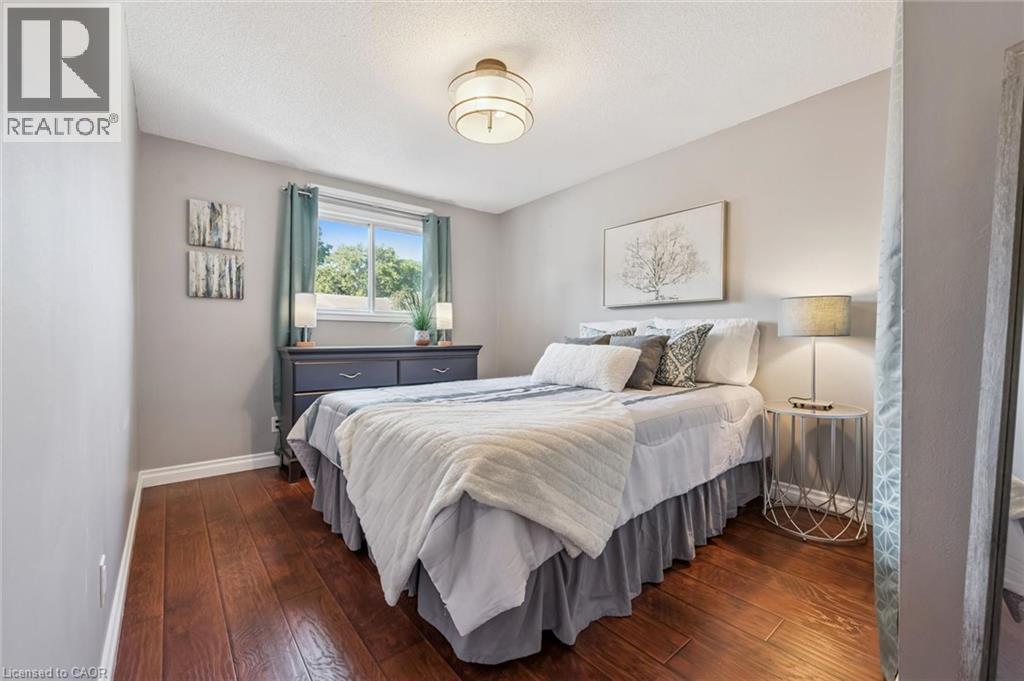 Hardwood-finish flooring, neutral wall tones, window with natural light, and a flush-mount ceiling fixture - 460 Parkview Crescent, Cambridge, ON - Indoor Photo Showing Bedroom