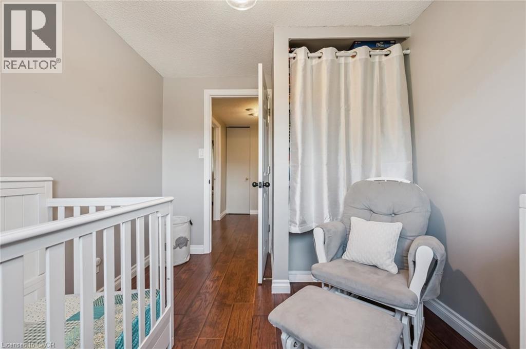 Hardwood flooring with a matte finish, light grey wall paint, and a built-in open closet space - 460 Parkview Crescent, Cambridge, ON - Indoor Photo Showing Bedroom