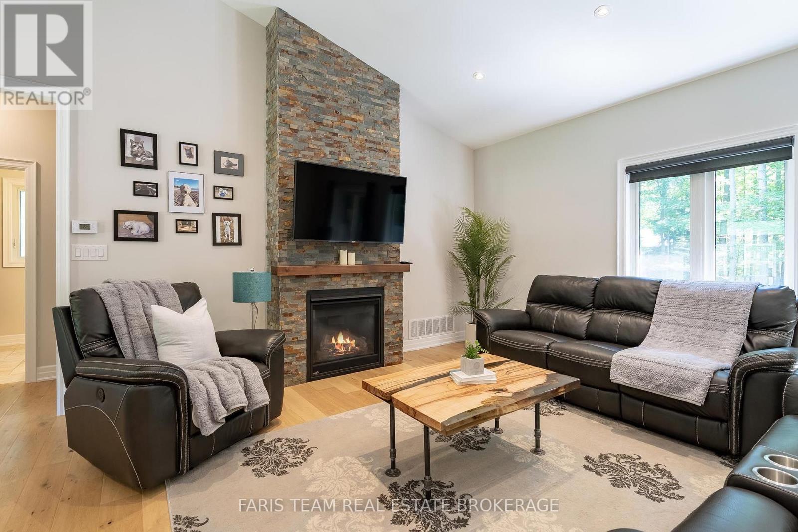 41 Tall Pines Drive, Tiny, ON - Indoor Photo Showing Living Room With Fireplace
