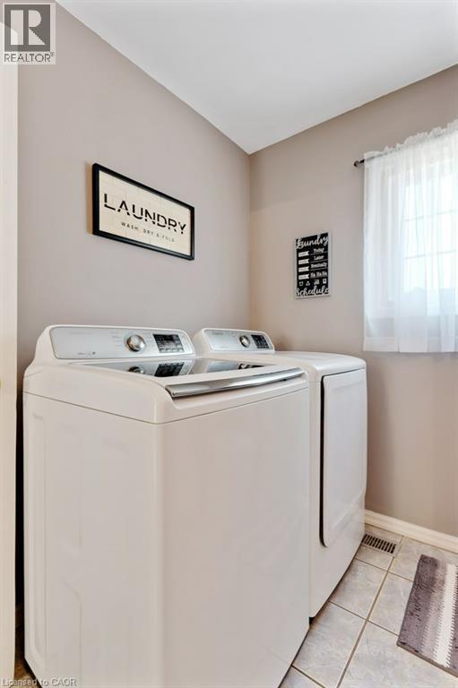 Tiled flooring with neutral wall tones - 236 Winston Boulevard, Cambridge, ON - Indoor Photo Showing Laundry Room