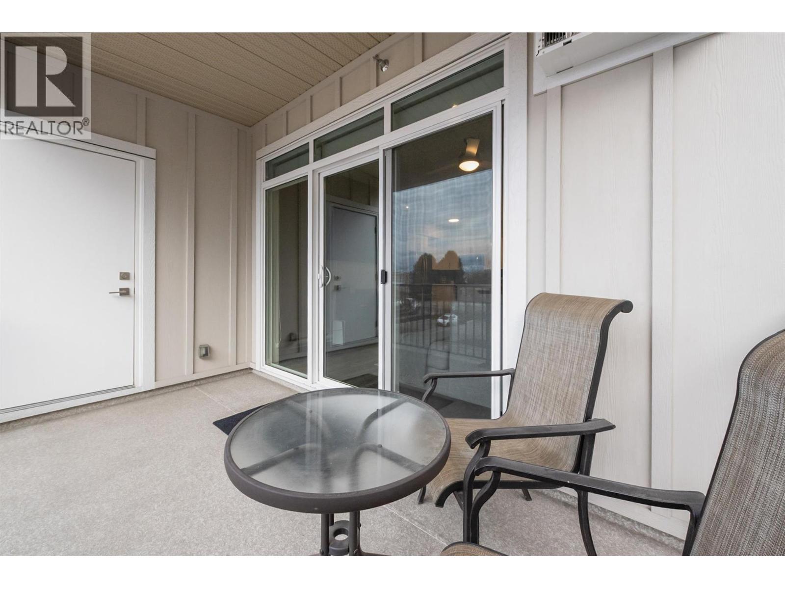 Nice size deck with sliding patio door to allow full use of the space. Note: Additional full size storage room behind the door! In addition to a same floor storage room beside the unit. - 3090 Burtch Road Unit# 201, Kelowna, BC - Indoor Photo Showing Living Room