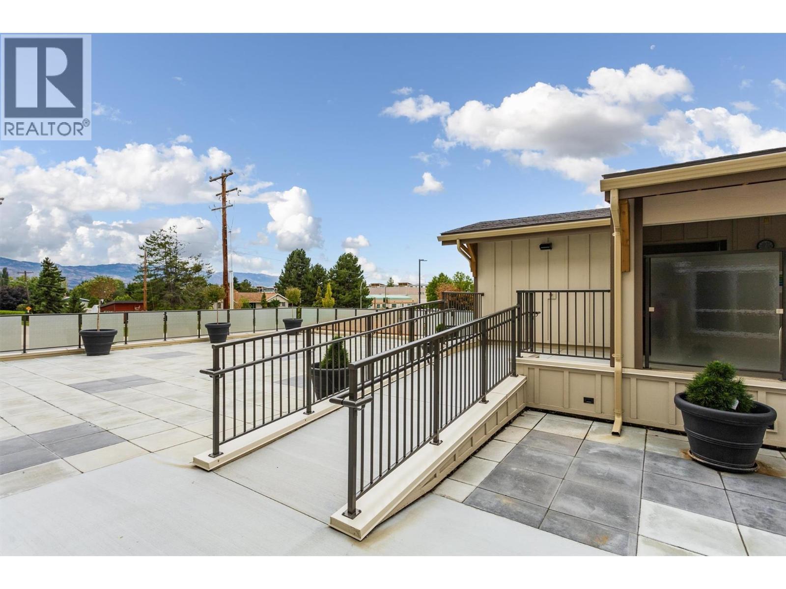 Outside Entrance to Common area deck and hot tub - 3090 Burtch Road Unit# 201, Kelowna, BC - Indoor Photo Showing Gym Room