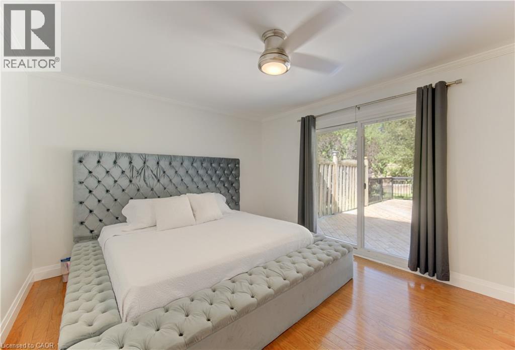 Hardwood flooring throughout featuring white walls and crown molding - 106 Autumn Hill Crescent, Kitchener, ON - Indoor Photo Showing Bedroom