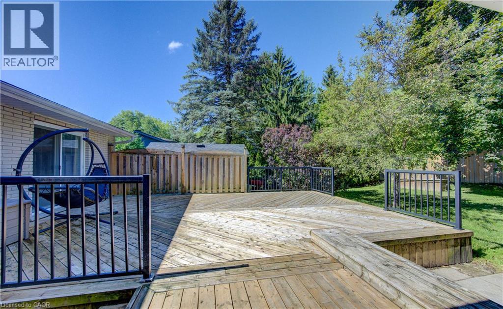 Multi-level wood deck featuring black metal railings and a built-in bench - 106 Autumn Hill Crescent, Kitchener, ON - Outdoor With Deck Patio Veranda